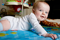 baby on blanket in floor doing Tummy Time.